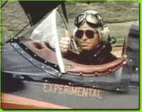 John Denver in his biplane - click to read an excerpt of his biography